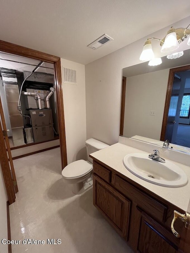 11019 W Crystal Bay Rd, Post Falls, ID 83854 - bathroom featuring vanity, toilet, and heating unit