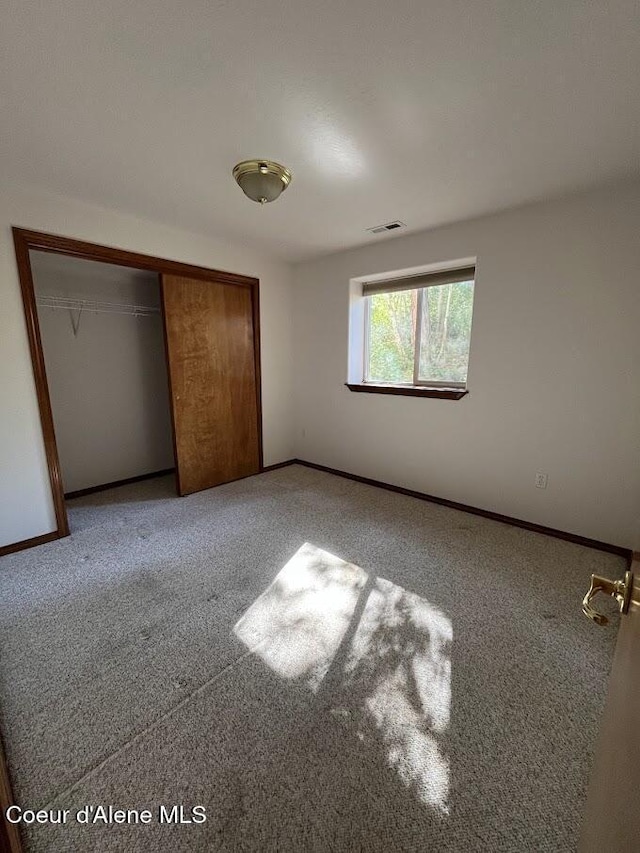 11019 W Crystal Bay Rd, Post Falls, ID 83854 - unfurnished bedroom with a closet, carpet flooring, and baseboards