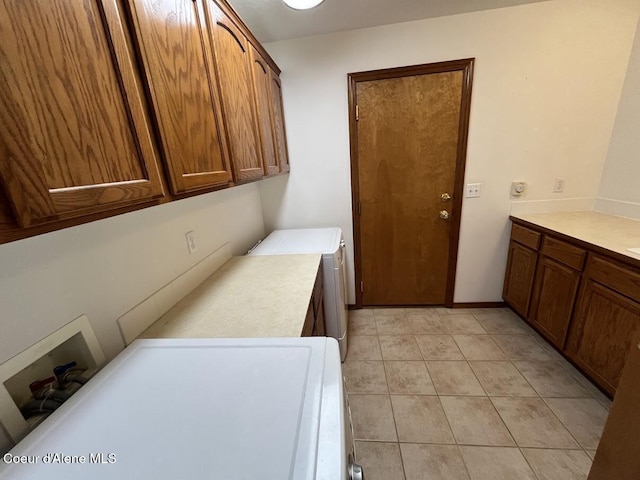 11019 W Crystal Bay Rd, Post Falls, ID 83854 - laundry room featuring cabinet space, washer and clothes dryer, and light tile patterned flooring