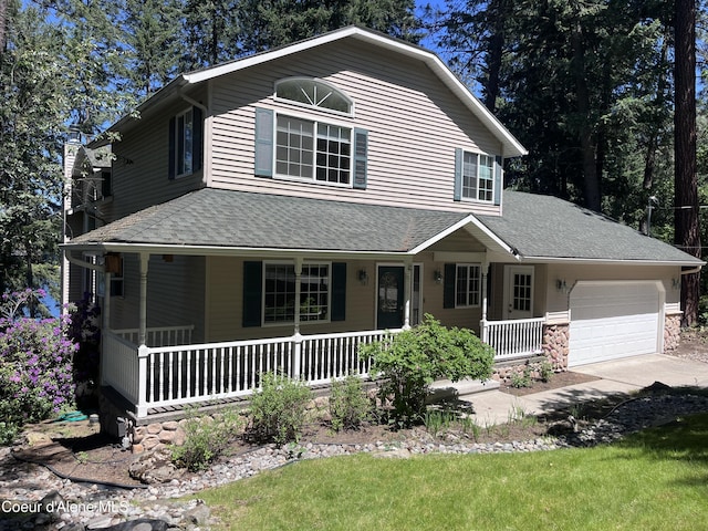 11019 W Crystal Bay Rd, Post Falls, ID 83854 - view of front of property with a porch, an attached garage, a shingled roof, and driveway