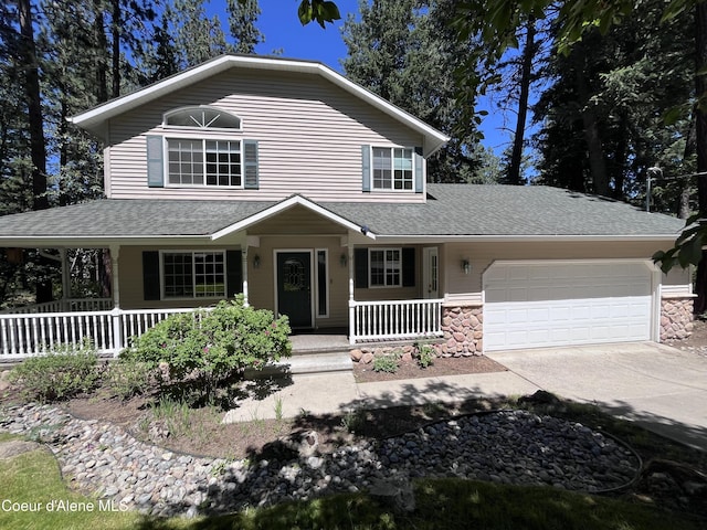 11019 W Crystal Bay Rd, Post Falls, ID 83854 - view of front facade with a porch, a garage, roof with shingles, and driveway