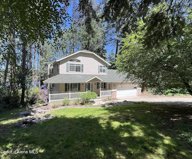 11019 W Crystal Bay Rd, Post Falls, ID 83854 - view of front of property with a porch, dirt driveway, a front yard, a garage, and roof with shingles