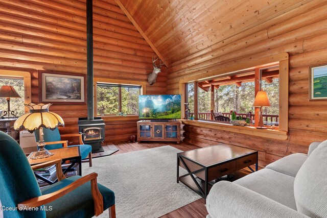 2609 W Seasons Rd, Athol, ID 83801 - living room with a wood stove, rustic walls, high vaulted ceiling, wood finished floors, and wood ceiling