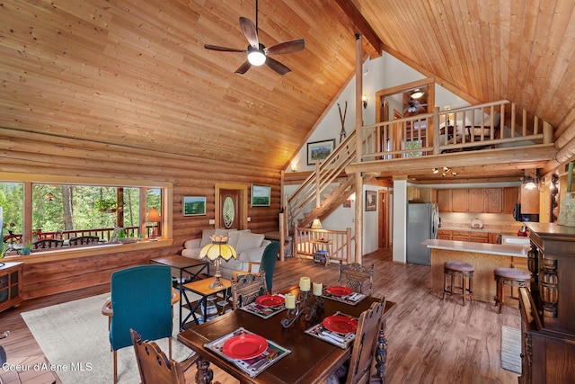 2609 W Seasons Rd, Athol, ID 83801 - living room with high vaulted ceiling, wooden ceiling with exposed beams, rustic walls, ceiling fan, and stairway