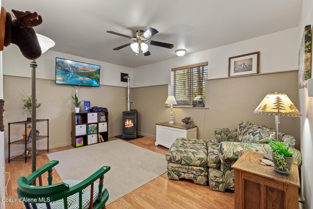 2609 W Seasons Rd, Athol, ID 83801 - living area featuring ceiling fan, a wood stove, wood finished floors, and baseboards