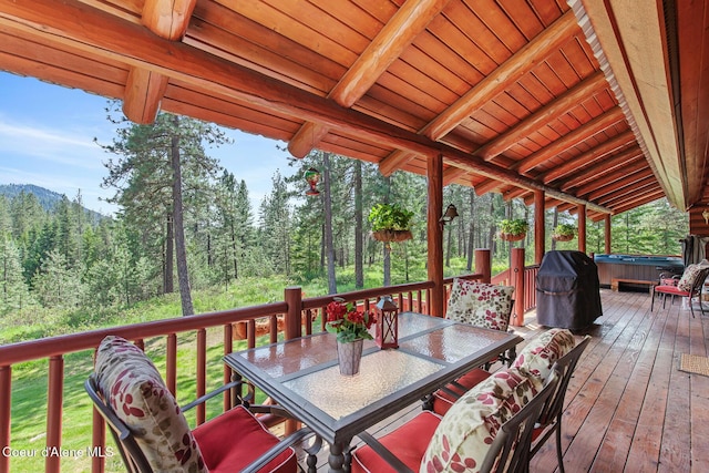 2609 W Seasons Rd, Athol, ID 83801 - wooden deck featuring a hot tub, outdoor dining area, area for grilling, and a view of trees