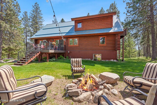 2609 W Seasons Rd, Athol, ID 83801 - back of property featuring an outdoor fire pit, log exterior, stairway, metal roof, and a yard