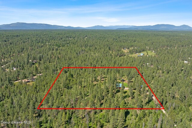 2609 W Seasons Rd, Athol, ID 83801 - aerial overview of property's location featuring a forest, a mountain backdrop, and property boundaries highlighted