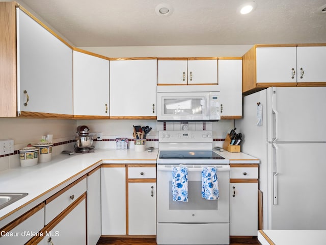 26370 S Hinds Dr, Saint Maries, ID 83861 - kitchen featuring white appliances, light countertops, white cabinets, and recessed lighting