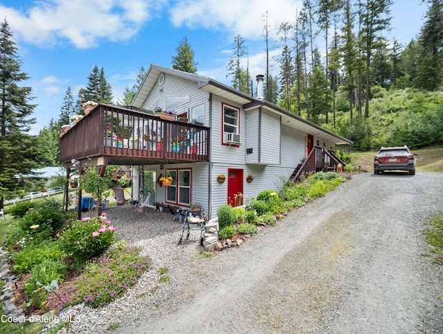 26370 S Hinds Dr, Saint Maries, ID 83861 - view of side of property with dirt driveway, a wooden deck, and cooling unit