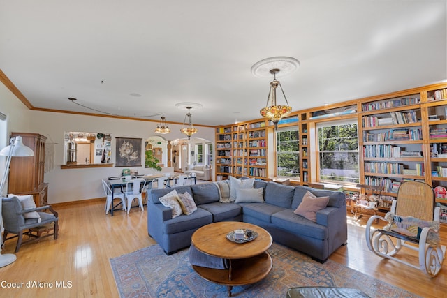 7260 N Courcelles Pkwy, Coeur Dalene, ID 83815 - living room with plenty of natural light, crown molding, wood finished floors, and arched walkways
