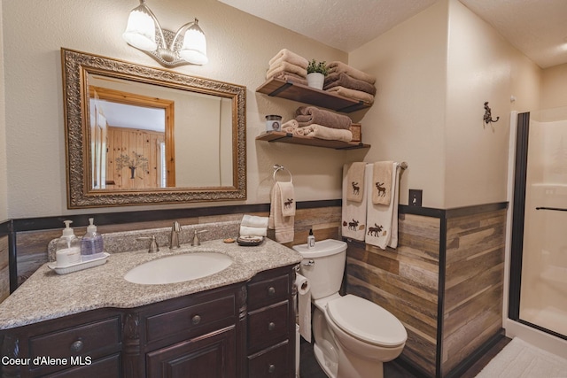 15964 N Songbird Ln, Rathdrum, ID 83858 - bathroom featuring wainscoting, tile walls, vanity, and a chandelier