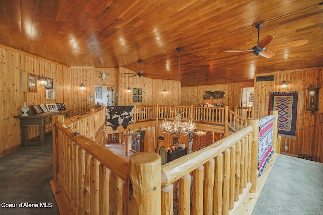 15964 N Songbird Ln, Rathdrum, ID 83858 - corridor with an upstairs landing, wooden walls, wood ceiling, carpet floors, and a chandelier