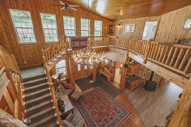 15964 N Songbird Ln, Rathdrum, ID 83858 - dining area featuring wood walls, a ceiling fan, a wood stove, lofted ceiling, and wood finished floors