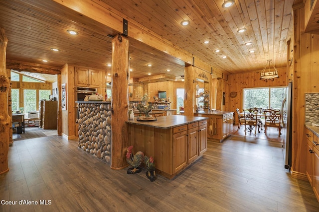 15964 N Songbird Ln, Rathdrum, ID 83858 - kitchen with dark wood-style floors, brown cabinets, stainless steel appliances, recessed lighting, and wood ceiling