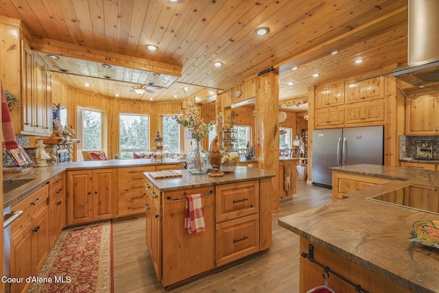 15964 N Songbird Ln, Rathdrum, ID 83858 - kitchen featuring freestanding refrigerator, light wood-type flooring, wooden ceiling, a center island, and recessed lighting