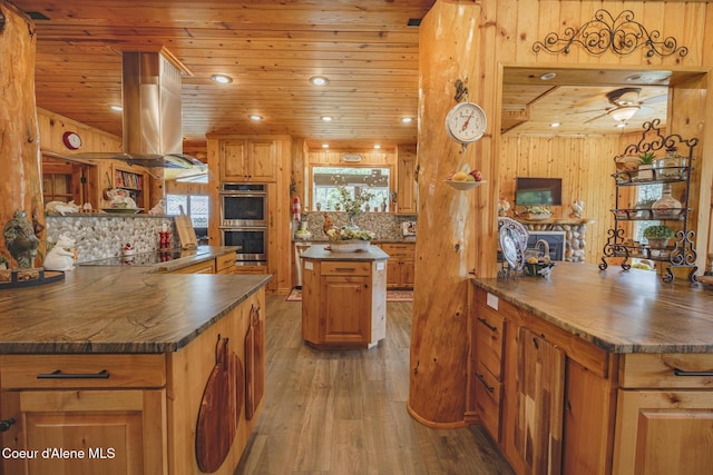 15964 N Songbird Ln, Rathdrum, ID 83858 - kitchen featuring double oven, dark countertops, wooden ceiling, black electric stovetop, and light wood finished floors