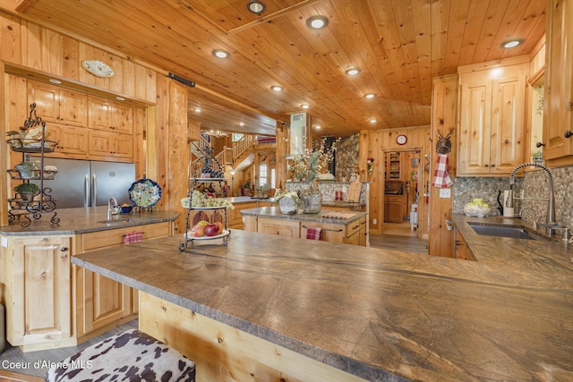 15964 N Songbird Ln, Rathdrum, ID 83858 - kitchen featuring a peninsula, a kitchen island, wood ceiling, recessed lighting, and tasteful backsplash