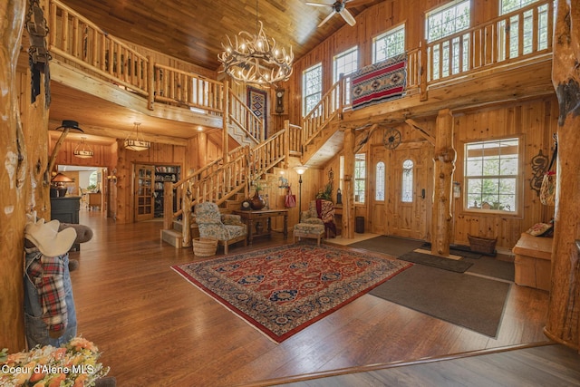 15964 N Songbird Ln, Rathdrum, ID 83858 - entryway featuring high vaulted ceiling, wooden walls, stairs, a chandelier, and wood ceiling