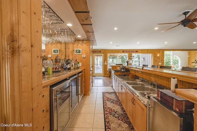 15964 N Songbird Ln, Rathdrum, ID 83858 - kitchen with wine cooler, a ceiling fan, recessed lighting, light tile patterned floors, and dark countertops