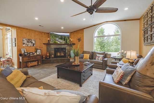 15964 N Songbird Ln, Rathdrum, ID 83858 - living room featuring wood walls, recessed lighting, crown molding, ceiling fan, and a fireplace