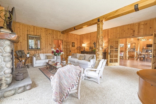 15964 N Songbird Ln, Rathdrum, ID 83858 - carpeted living area featuring wooden walls, beamed ceiling, and a textured ceiling