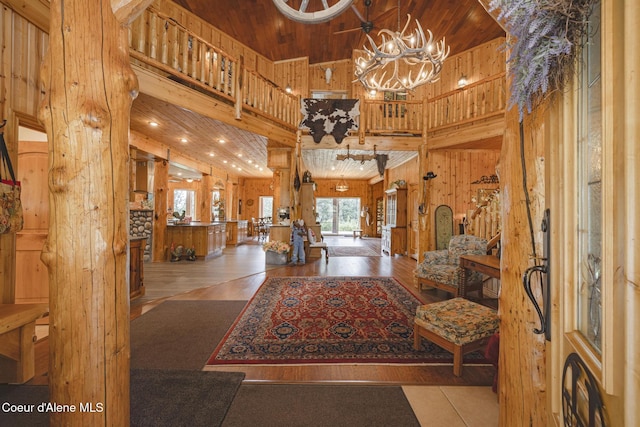 15964 N Songbird Ln, Rathdrum, ID 83858 - entryway with a towering ceiling, wooden walls, wood ceiling, wood finished floors, and a chandelier