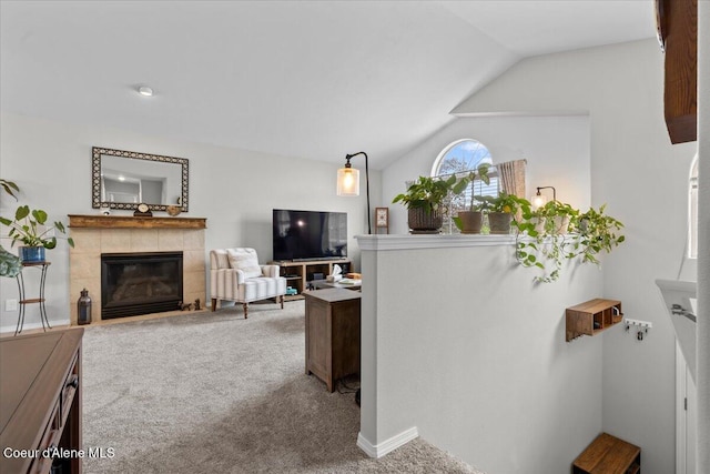 2574 W Sarge Ct, Coeur Dalene, ID 83815 - carpeted living area featuring a tile fireplace and vaulted ceiling