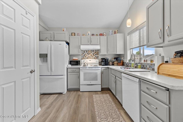 2574 W Sarge Ct, Coeur Dalene, ID 83815 - kitchen featuring white appliances, under cabinet range hood, gray cabinetry, a sink, and light wood-style flooring