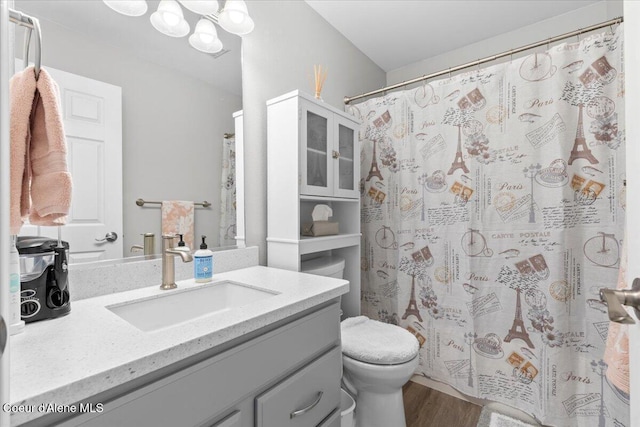 2574 W Sarge Ct, Coeur Dalene, ID 83815 - full bath featuring vanity, toilet, wood finished floors, a chandelier, and curtained shower