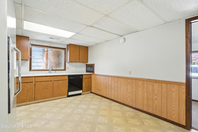 1031 N 11th St, Coeur Dalene, ID 83814 - kitchen featuring black appliances, light floors, a drop ceiling, a wainscoted wall, and a sink