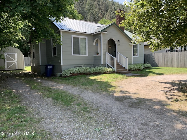 705 S Division St, Kellogg, ID 83837 - bungalow with a chimney, metal roof, and driveway