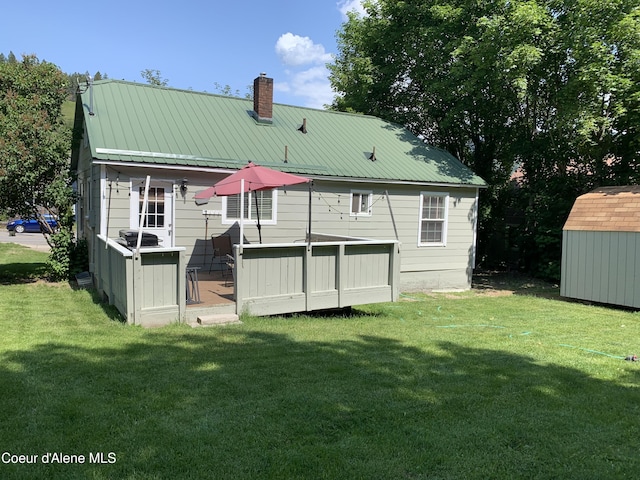 705 S Division St, Kellogg, ID 83837 - back of house featuring a chimney, a yard, metal roof, and a deck