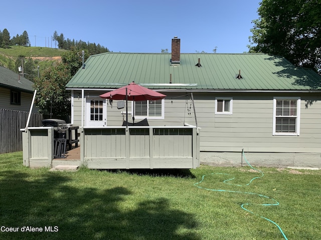 705 S Division St, Kellogg, ID 83837 - rear view of house with a chimney, a wooden deck, and metal roof