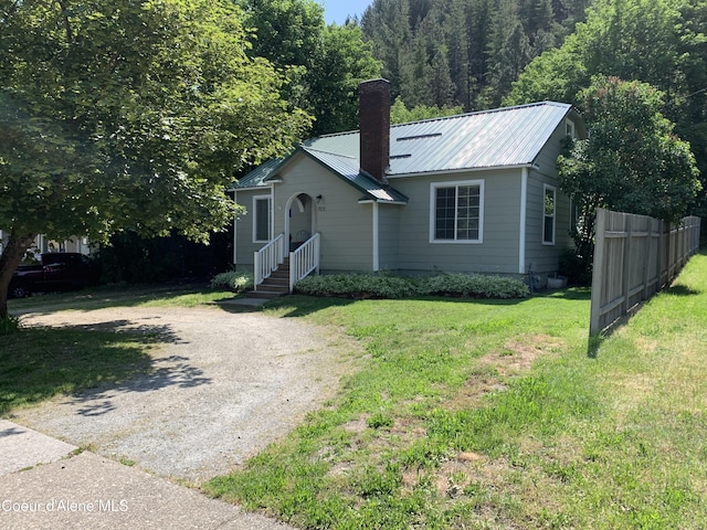 705 S Division St, Kellogg, ID 83837 - view of front of house with dirt driveway, a chimney, and metal roof