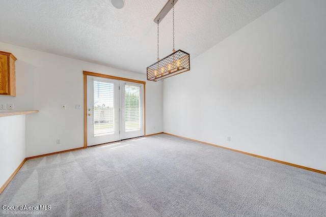 1555 W Benjamin Ave, Coeur Dalene, ID 83815 - unfurnished dining area featuring a textured ceiling and light colored carpet