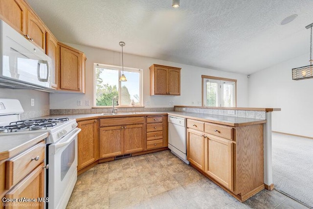 1555 W Benjamin Ave, Coeur Dalene, ID 83815 - kitchen with white appliances, a peninsula, light countertops, hanging light fixtures, and a textured ceiling