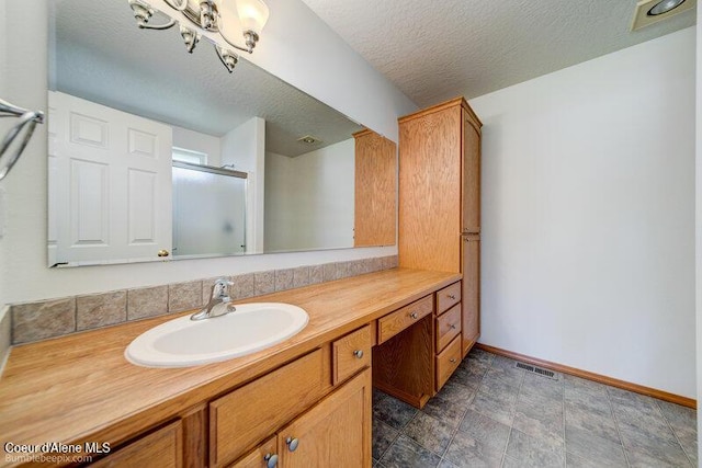 1555 W Benjamin Ave, Coeur Dalene, ID 83815 - full bath with vanity, an enclosed shower, and a textured ceiling