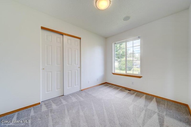 1555 W Benjamin Ave, Coeur Dalene, ID 83815 - unfurnished bedroom with carpet and a closet
