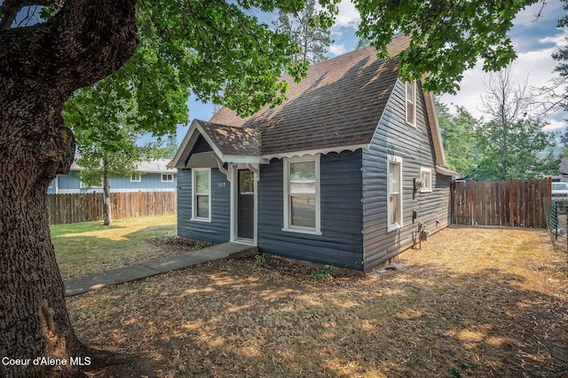 1412/1414 N 13th St, Coeur Dalene, ID 83814 - view of front of house with a shingled roof and a fenced backyard