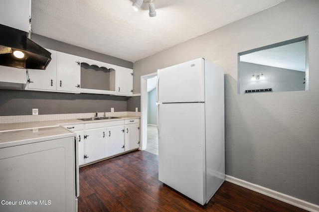 1412/1414 N 13th St, Coeur Dalene, ID 83814 - kitchen featuring freestanding refrigerator, exhaust hood, washer / clothes dryer, dark wood finished floors, and white cabinetry