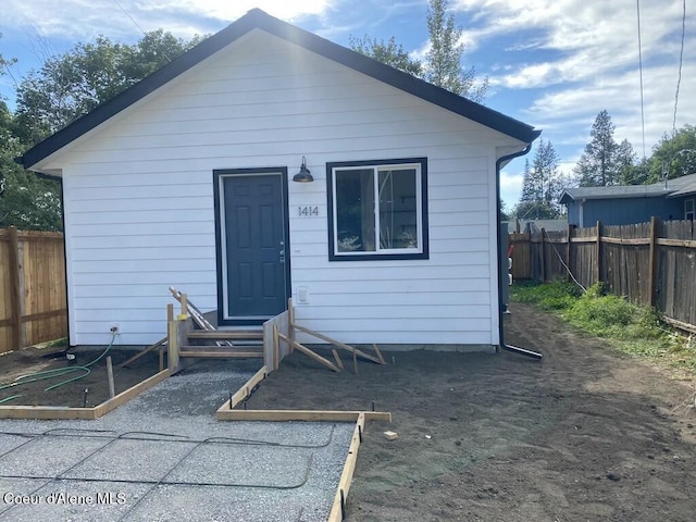 1412/1414 N 13th St, Coeur Dalene, ID 83814 - rear view of house with a fenced backyard and entry steps