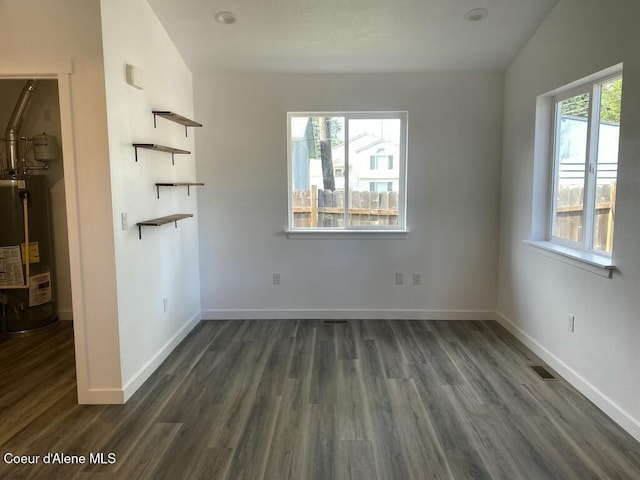 1412/1414 N 13th St, Coeur Dalene, ID 83814 - unfurnished living room featuring water heater and dark wood finished floors