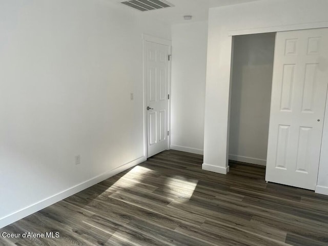 1412/1414 N 13th St, Coeur Dalene, ID 83814 - unfurnished bedroom featuring dark wood finished floors and a closet