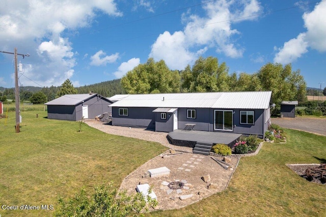 331 15th St, Plummer, ID 83851 - rear view of property with a lawn, a wooden deck, and metal roof
