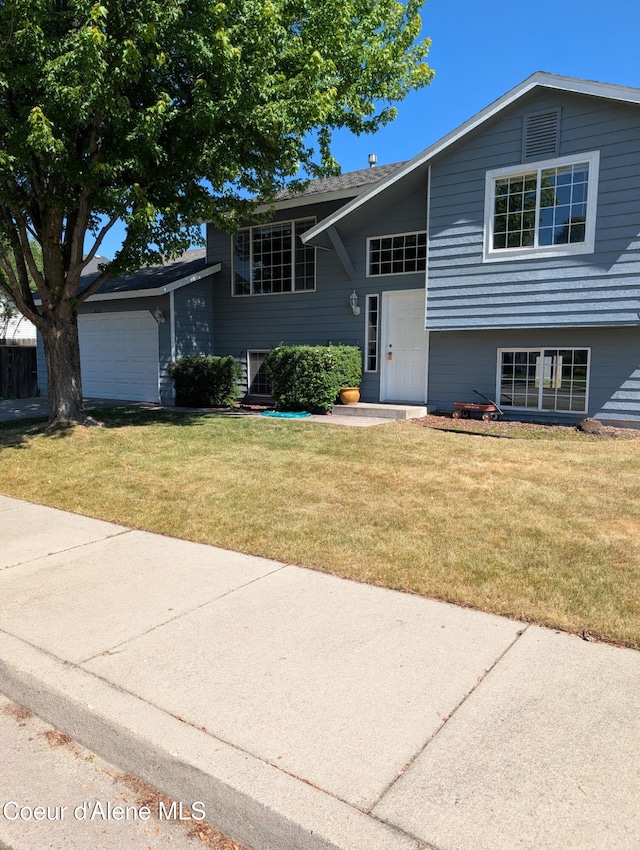 902 E Glacier Peak Dr, Post Falls, ID 83854 - view of front of home with an attached garage and a front yard