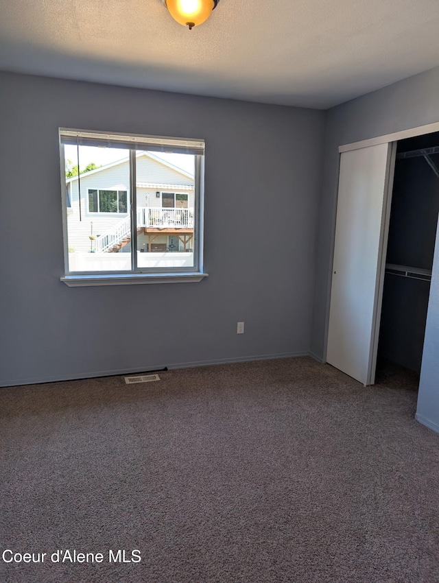 902 E Glacier Peak Dr, Post Falls, ID 83854 - unfurnished bedroom featuring a closet, carpet floors, and baseboards