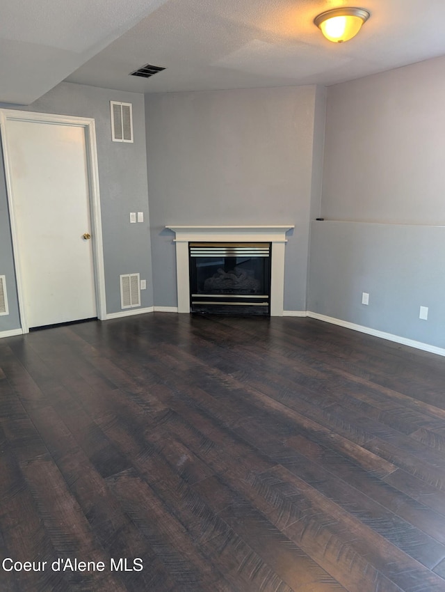 902 E Glacier Peak Dr, Post Falls, ID 83854 - unfurnished living room with wood finished floors, a glass covered fireplace, and baseboards