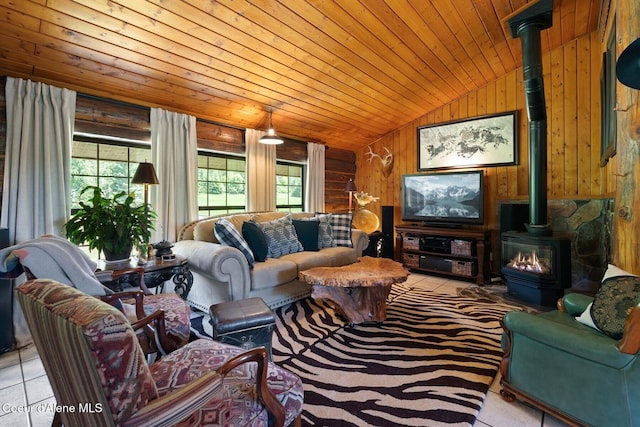 343 W Spring Creek Rd, Hope, ID 83836 - living room with vaulted ceiling, a wood stove, wood ceiling, light tile patterned flooring, and wood walls