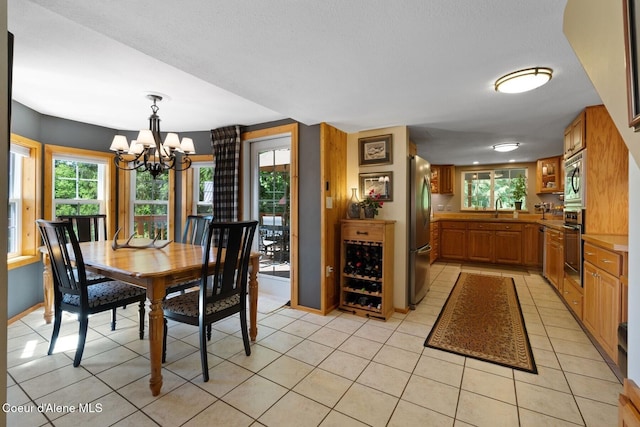 343 W Spring Creek Rd, Hope, ID 83836 - dining space featuring a chandelier, light tile patterned flooring, and baseboards